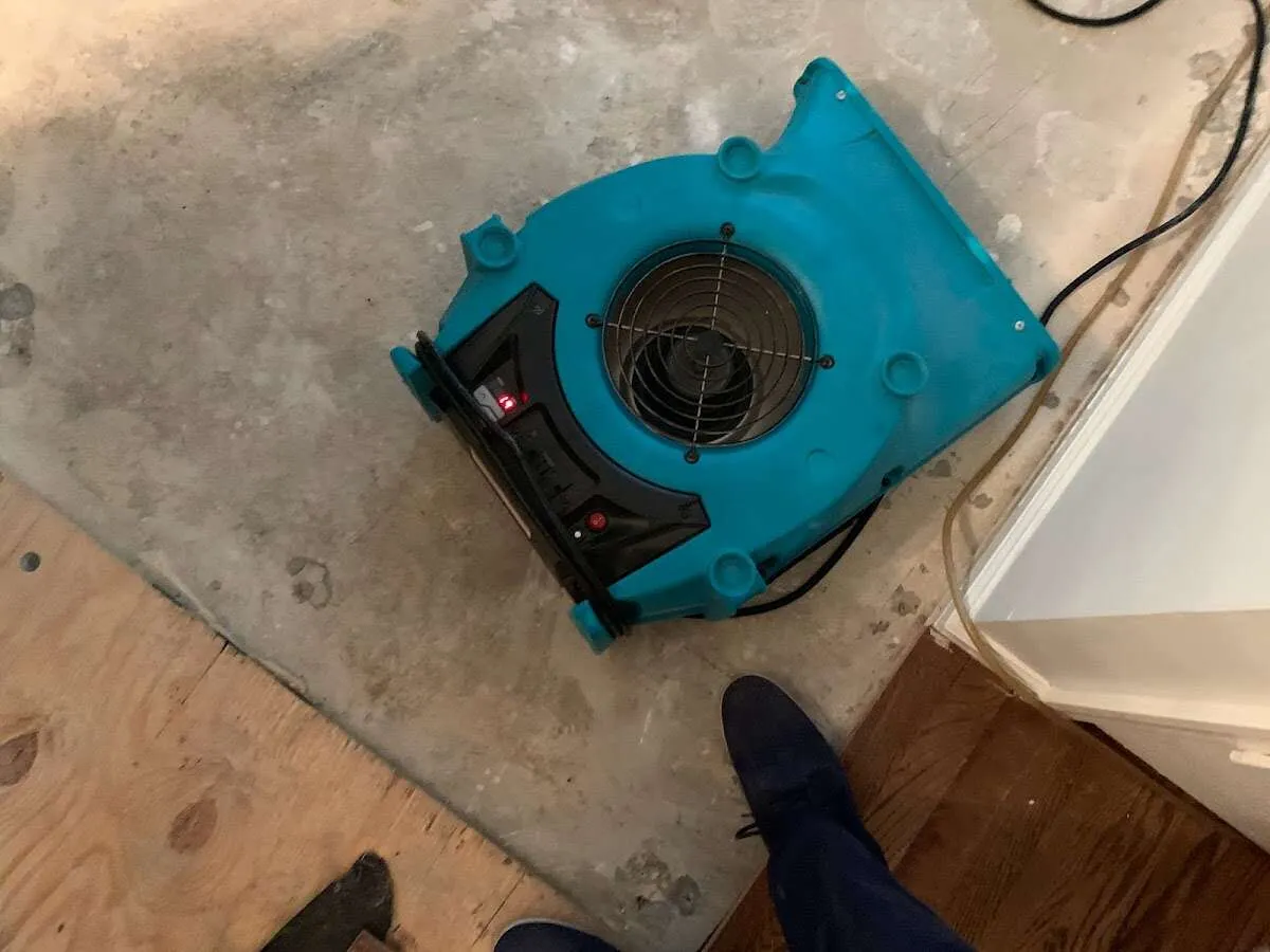 Air mover drying subfloor during Leak Detection & Repair in Garrett